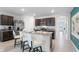 Open concept kitchen with island seating and stainless steel appliances at 316 Corso Loop, Winter Haven, FL 33884