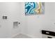 Laundry room with white walls and built-in storage at 316 Corso Loop, Winter Haven, FL 33884