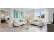Living area featuring white sofas, a glass-top coffee table and view of bedroom at 316 Corso Loop, Winter Haven, FL 33884