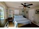 Bedroom with a queen bed, wood-look floors and sliding glass doors leading to the pool at 326 Benton St, Orlando, FL 32839