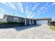 Gray house with a white garage and a paved driveway at 326 Benton St, Orlando, FL 32839