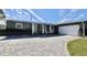 Ranch-style home with gray siding, white garage, and paver driveway at 326 Benton St, Orlando, FL 32839