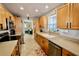 Bright kitchen with stainless steel appliances and light wood cabinets at 326 Benton St, Orlando, FL 32839
