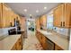 Modern kitchen with stainless steel appliances and light wood cabinets at 326 Benton St, Orlando, FL 32839