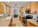 Updated kitchen boasts stainless steel appliances and wood cabinetry at 326 Benton St, Orlando, FL 32839