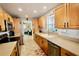 Bright kitchen with stainless steel appliances and light wood cabinets at 326 Benton St, Orlando, FL 32839