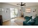 Living area showcasing a teal sectional and access to backyard at 326 Benton St, Orlando, FL 32839