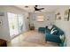 Living area showcasing a teal sectional and access to backyard at 326 Benton St, Orlando, FL 32839