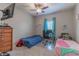Cozy bedroom with twin beds, a desk, and plenty of natural light at 3583 Conroy Rd # 1135, Orlando, FL 32839