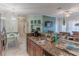 Open kitchen with granite countertops, stainless steel appliances, and a view of dining area at 3583 Conroy Rd # 1135, Orlando, FL 32839