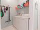 Convenient laundry room with washer, dryer, and shelving for storage at 3583 Conroy Rd # 1135, Orlando, FL 32839