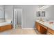 Bathroom featuring a soaking tub, tile flooring, and a wooden vanity with double sinks at 3689 Rolling Hills Ln, Apopka, FL 32712