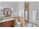 Well-lit bathroom featuring a glass enclosed shower, and a vanity with mosaic tile backsplash at 3689 Rolling Hills Ln, Apopka, FL 32712