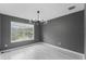 Bedroom featuring modern light fixture, light wood floors and a large window with natural light at 3689 Rolling Hills Ln, Apopka, FL 32712