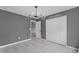 Bedroom featuring modern light fixture, light wood floors, closet, and natural light at 3689 Rolling Hills Ln, Apopka, FL 32712