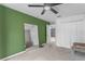 Spacious bedroom with a unique green accent wall, neutral carpet and multiple closets at 3689 Rolling Hills Ln, Apopka, FL 32712