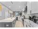 Bright kitchen featuring marble countertops, white cabinetry, and a large island with a modern design at 3689 Rolling Hills Ln, Apopka, FL 32712