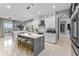 Spacious kitchen featuring an island with seating, white cabinets, and modern appliances, ideal for Gathering gatherings at 3689 Rolling Hills Ln, Apopka, FL 32712
