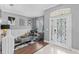 Elegant living room with modern decor, stylish furniture, and decorative front door, perfect for welcoming guests at 3689 Rolling Hills Ln, Apopka, FL 32712