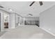 Open loft area with neutral carpet, ceiling fan, and a black railing, offering flexible living space at 3689 Rolling Hills Ln, Apopka, FL 32712