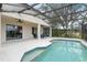 Sparkling screened-in pool with attached patio and seating area, perfect for relaxing and entertaining at 3689 Rolling Hills Ln, Apopka, FL 32712