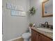 Modern bathroom with stylish vanity and patterned wallpaper at 385 Alcove Dr, Groveland, FL 34736