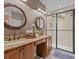 Double vanity bathroom with granite countertops and large shower at 385 Alcove Dr, Groveland, FL 34736