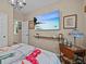 Cozy bedroom with large TV, comfortable bedding, and side table at 385 Alcove Dr, Groveland, FL 34736