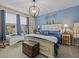 Primary bedroom with king-size bed and blue color scheme at 385 Alcove Dr, Groveland, FL 34736