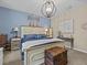 Primary bedroom with king-size bed and tranquil decor at 385 Alcove Dr, Groveland, FL 34736
