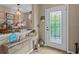 Light and airy entryway with decorative console table and a view into the dining area at 385 Alcove Dr, Groveland, FL 34736