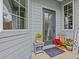 Inviting front entry with decorative planters and a welcome sign at 385 Alcove Dr, Groveland, FL 34736