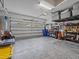 Garage with overhead storage and ample space for tools and vehicles at 385 Alcove Dr, Groveland, FL 34736