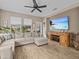 Spacious Gathering room with an L-shaped sectional sofa and large flat-screen TV at 385 Alcove Dr, Groveland, FL 34736
