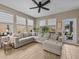 Spacious Gathering room featuring an L-shaped sofa and access to the backyard at 385 Alcove Dr, Groveland, FL 34736