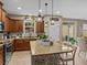 Modern kitchen with granite countertops, stainless steel appliances and an island at 385 Alcove Dr, Groveland, FL 34736