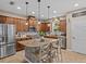 Spacious kitchen with island, stainless steel appliances, and ample cabinetry at 385 Alcove Dr, Groveland, FL 34736