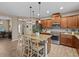 Modern kitchen with granite countertops, stainless steel appliances, and an island with seating at 385 Alcove Dr, Groveland, FL 34736