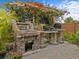 Brick outdoor kitchen with grill and pergola, perfect for entertaining at 385 Alcove Dr, Groveland, FL 34736