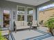 Relaxing covered patio with comfortable seating and a view of the yard at 385 Alcove Dr, Groveland, FL 34736