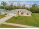 Aerial view of a single-story house with a spacious front yard and driveway at 4572 Woodcove Dr, Port Orange, FL 32127