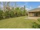Landscaped backyard with mature trees and privacy at 4572 Woodcove Dr, Port Orange, FL 32127