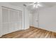 Bedroom with wood-look flooring and louvered doors at 4572 Woodcove Dr, Port Orange, FL 32127