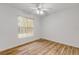 Bedroom with wood-look flooring and large window at 4572 Woodcove Dr, Port Orange, FL 32127