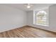 Bright bedroom featuring an arched window and ceiling fan at 4572 Woodcove Dr, Port Orange, FL 32127