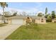 House exterior featuring a one-story home with a front yard and attached garage at 4572 Woodcove Dr, Port Orange, FL 32127