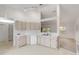 Kitchen boasts ample cabinetry, a breakfast nook, and a view into the living room at 4572 Woodcove Dr, Port Orange, FL 32127
