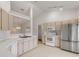 Modern kitchen featuring stainless steel appliances and light wood cabinets at 4572 Woodcove Dr, Port Orange, FL 32127