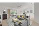 Bright living room featuring gray sofa, yellow pillows, and access to a relaxing patio at 4572 Woodcove Dr, Port Orange, FL 32127