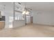 Open living room with a view of the kitchen and access to other areas at 4572 Woodcove Dr, Port Orange, FL 32127